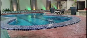 a swimming pool in the middle of a building at Hotel Oasis in Riberalta