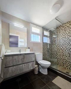 a bathroom with a sink and a toilet and a shower at Villa Narok in Tarajalejo +17 photos
