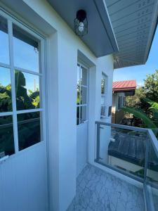 a front door of a house with a balcony at Modern Loft-Balcony-FullAC open space in Calumpit