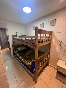 a room with two bunk beds in a room at House in Alta Vista Complex in San Martín