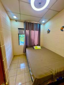 a small room with a bed and a window at House in Alta Vista Complex in San Martín +17 photos
