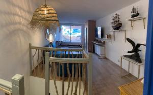 a living room with a table and a chandelier at L'Albatros in Marseille