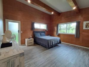 a bedroom with a bed in a room with wooden walls at Hope Villa in Muri
