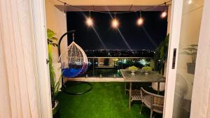 a balcony with a table and a view of the city at Elysium Tower Luxury Family Apartments Opposite Centaurus Mall Islamabad in Islamabad