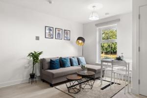 a living room with a couch and a table at Modern 2-Bed House 10-min to Leeds City Centre in Leeds