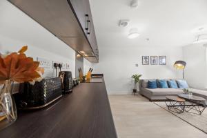 a living room with a couch and a table at Modern 2-Bed House 10-min to Leeds City Centre in Leeds