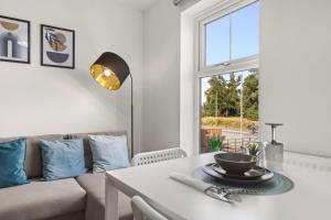 a living room with a couch and a table at Modern 2-Bed House 10-min to Leeds City Centre in Leeds