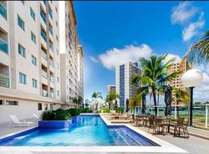 a swimming pool in front of a building at Salinas Park Resort in Salinópolis