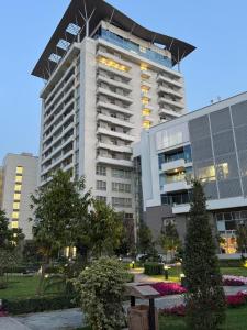 a large building with a flag on top of it at Penta Square Superior Executive Apartments-DHA Lahore in Lahore