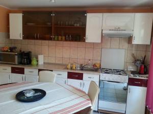 a kitchen with white cabinets and a table with a plate on it at Casa Brad Sovata in Sovata