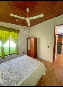 a bedroom with a bed and a ceiling fan at Casa Jicaro in Nosara