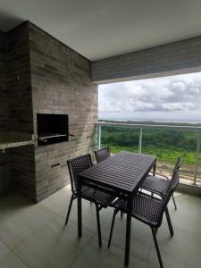 a dining room with a table and chairs and a fireplace at Salinas Park Resort in Salinópolis