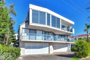 a large white house with a balcony at Palm Beach 33B Shoal Bay Road in Shoal Bay