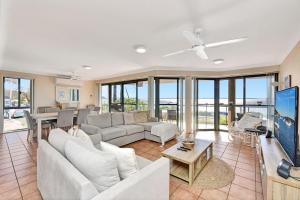 a living room with a couch and a table at Palm Beach 33B Shoal Bay Road in Shoal Bay