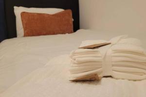 a stack of folded towels on a bed at Lakeside Apartment - 2 Bed, Free Parking in West Thurrock
