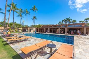 a swimming pool with chairs and a resort at Wailea Elua 808 - Scenic Ocean Views, Classic Wailea Charm, Central AC, Wi-Fi in Wailea