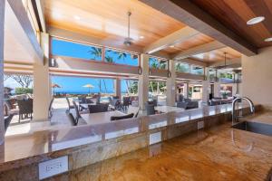 an open kitchen and dining room with a view of the ocean at Wailea Elua 808 - Scenic Ocean Views, Classic Wailea Charm, Central AC, Wi-Fi in Wailea