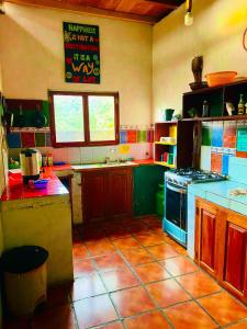 a kitchen with a counter and a stove top oven at Lazy Crab Hostel in Balgue
