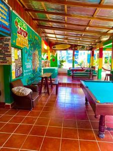 a restaurant with a pool table in a room at Lazy Crab Hostel in Balgue