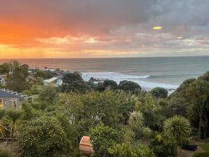 a view of the ocean from a resort at G SPOT UPPER LEVEL with spa in Raglan