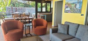 a living room with a couch and chairs and a table at G SPOT UPPER LEVEL with spa in Raglan