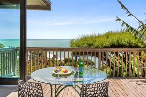 a glass table with a bowl of food on a balcony at G SPOT UPPER LEVEL with spa in Raglan