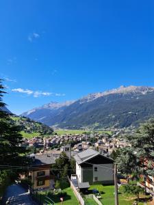 a view of a town with mountains in the background at Appartamento Panorama Bormio in Bormio
