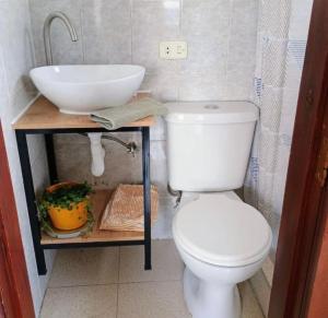 a bathroom with a white toilet and a sink at centrico departamento in Cusco