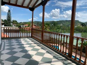 a balcony with a view of the water and mountains at Refugio de Paz Casa en Anapoima in Anapoima +9 photos
