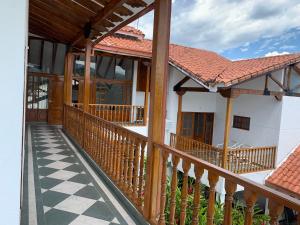 a porch of a house with a wooden railing at Refugio de Paz Casa en Anapoima in Anapoima