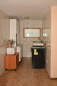 a kitchen with a sink and a stove in it at Cabañas Bosque Sur in Puerto Varas +87 photos