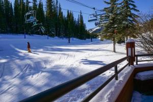 a person riding a ski lift in the snow at Beaver Run Resort 4228 - Dog Friendly in Breckenridge