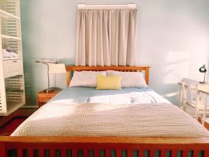 a bedroom with a large bed with a yellow pillow at Cozy 1Br Apt in Bangor