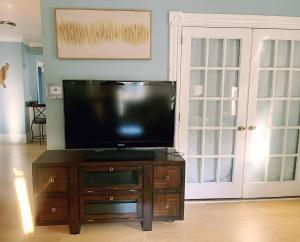 a flat screen tv sitting on top of a wooden cabinet at Cozy 1Br Apt in Bangor