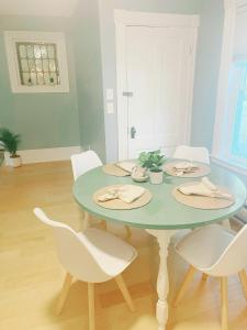 a dining room with a table and white chairs at Cozy 1Br Apt in Bangor +3 photos