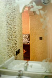 a mirror above a sink in a bathroom at The Rina Hostel in Agadir +37 photos