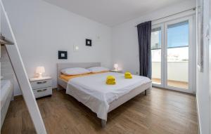 a bedroom with a bed with yellow towels on it at Nice Apartment In Povljana With Wifi in Povljana