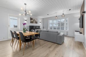 a living room with a table and a couch at Cozy Family Holiday Home in Hafnarfjördur