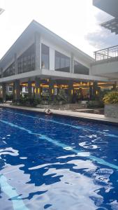 a swimming pool in front of a building at Condominium luxury with balcon ocean breeze in Davao City +12 photos