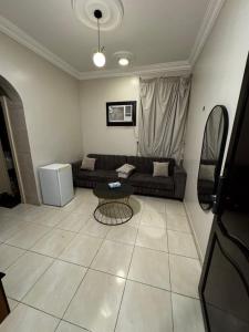 a living room with a couch and a table at شقق فايا in Jazan