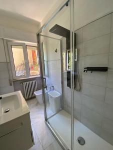 a bathroom with a shower and a toilet and a sink at Villa la Palma in Gemonio +56 photos
