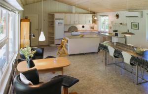 a kitchen with a table and chairs and a counter at Three-Bedroom Holiday Home In Ansager in Ansager