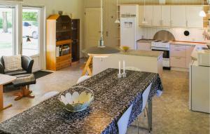 a kitchen with a table and a counter top at Three-Bedroom Holiday Home In Ansager in Ansager