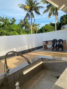 a kitchen with a sink on a roof with two chairs at Untung5tay in Gua Sai