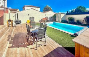 a backyard with a table and a swimming pool at 4 Bedroom Beautiful Home In Rognac in Rognac