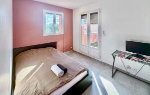 a bedroom with a bed and a desk with a television at 4 Bedroom Beautiful Home In Rognac in Rognac +6 photos