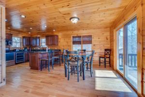 a kitchen with a table and chairs in a cabin at Majestic Manor - Peaceful Modern Cabin Retreat Near Watauga Lake in Butler
