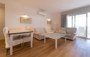 a living room with a couch and a table at Primavera in Colònia De Sant Jordi