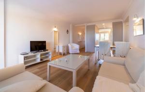 a living room with a couch and a table at Primavera in Colònia De Sant Jordi