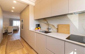 a kitchen with white cabinets and a sink at Primavera in Colònia De Sant Jordi +11 photos